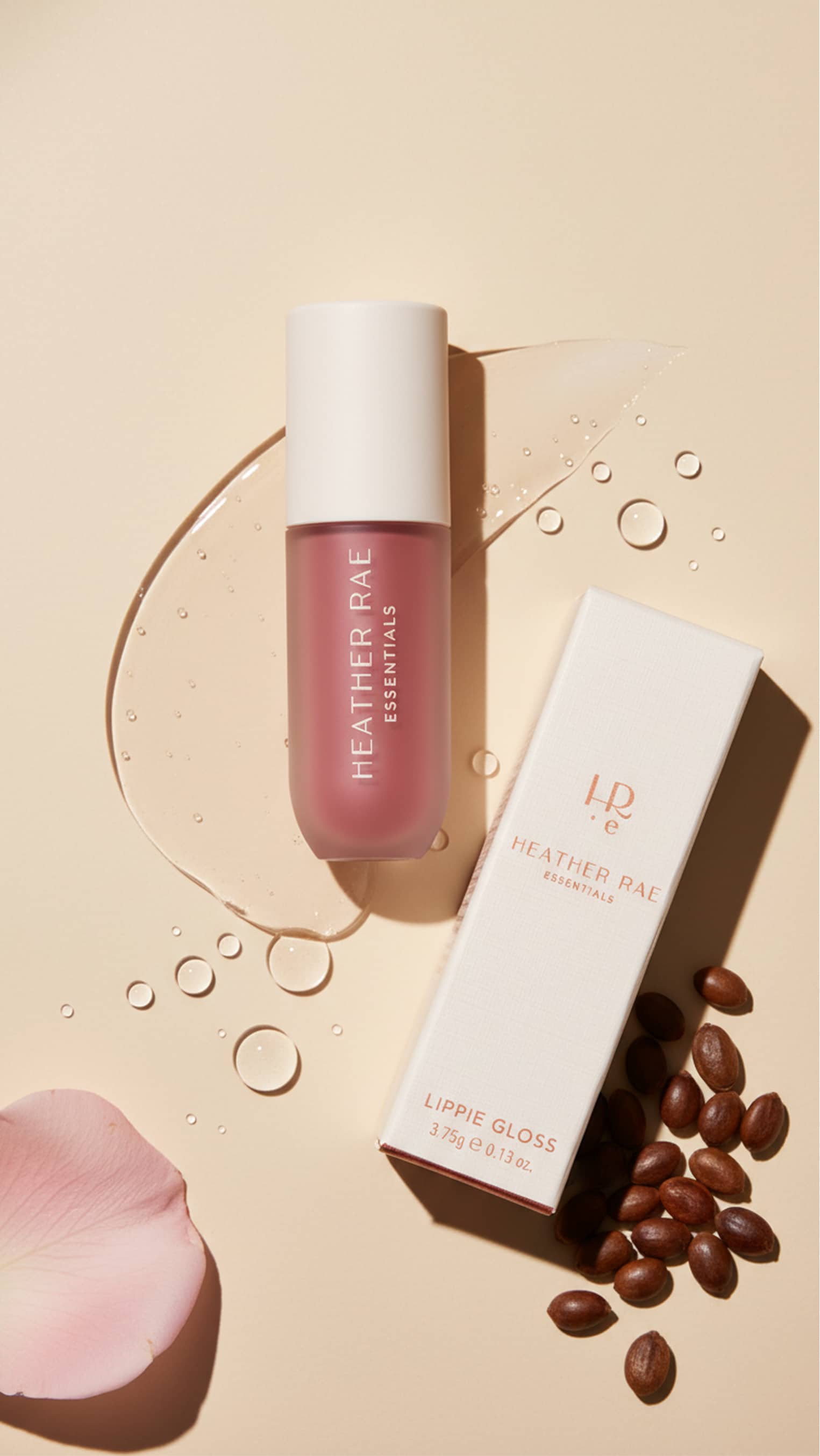 HRE lip gloss tube resting in sun-drenched water with crystalline refraction