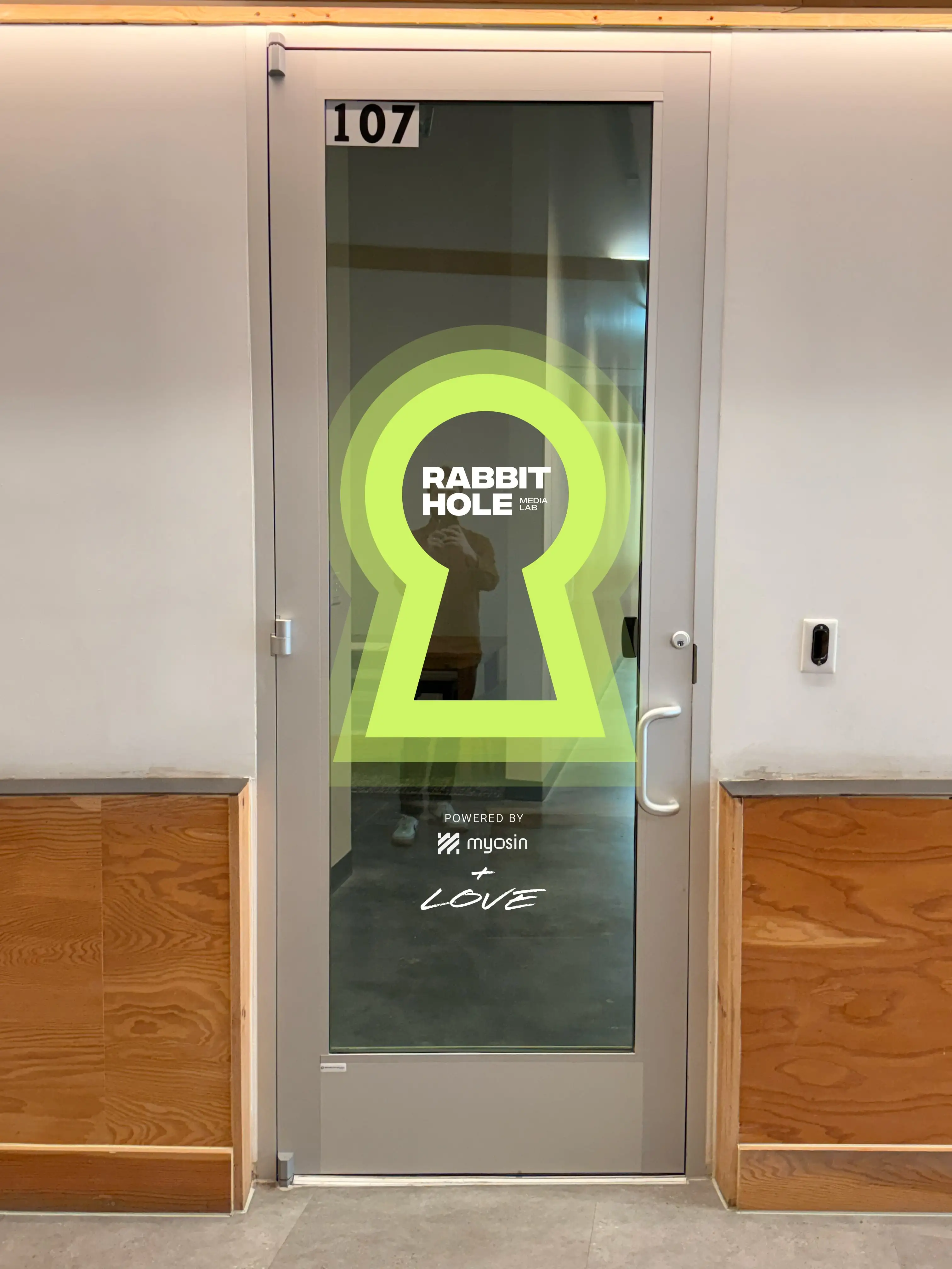 Rabbit Hole Room 107 studio door graphics in fluorescent chartreuse vinyl