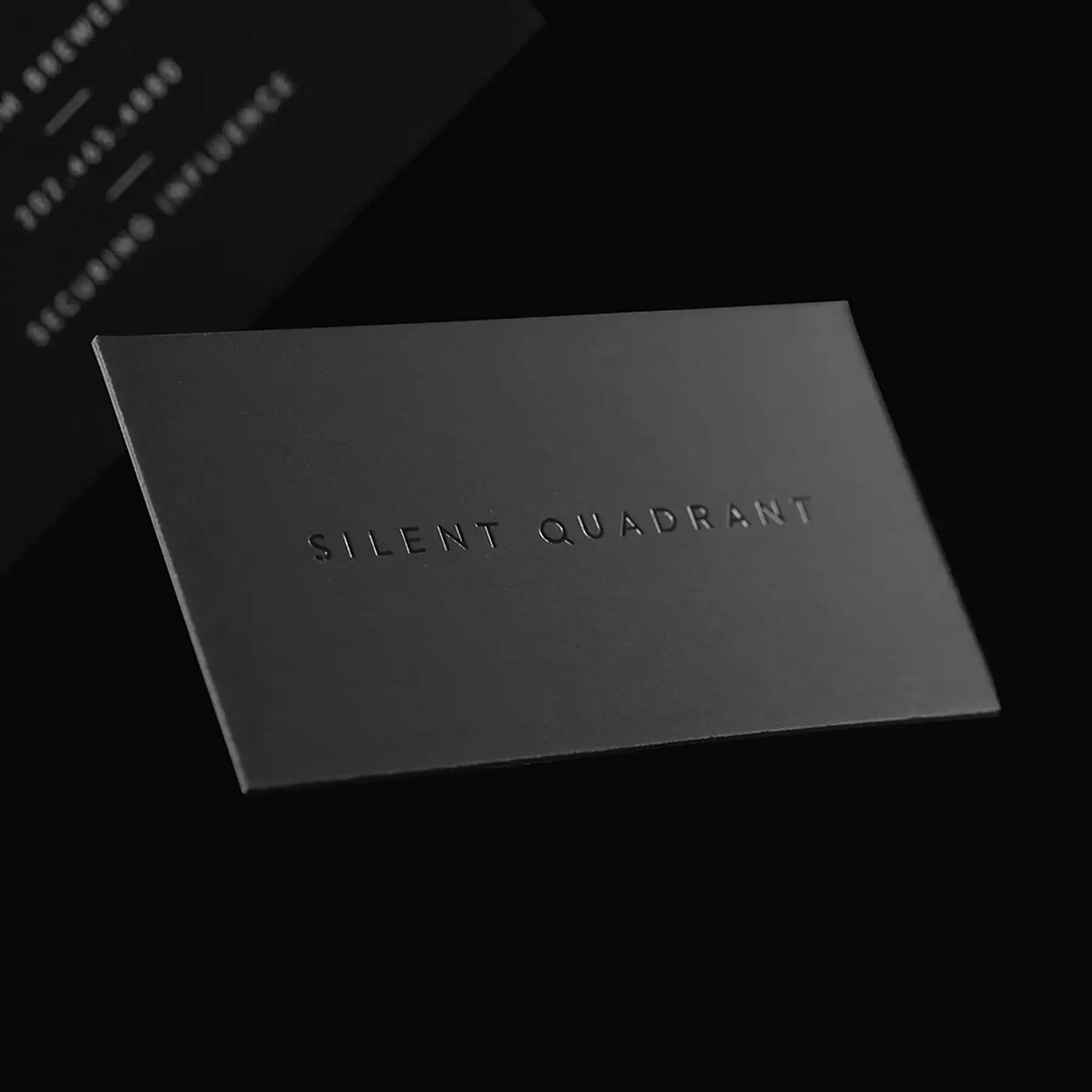 Silent Quadrant blind debossed business card on matte black duplex stock