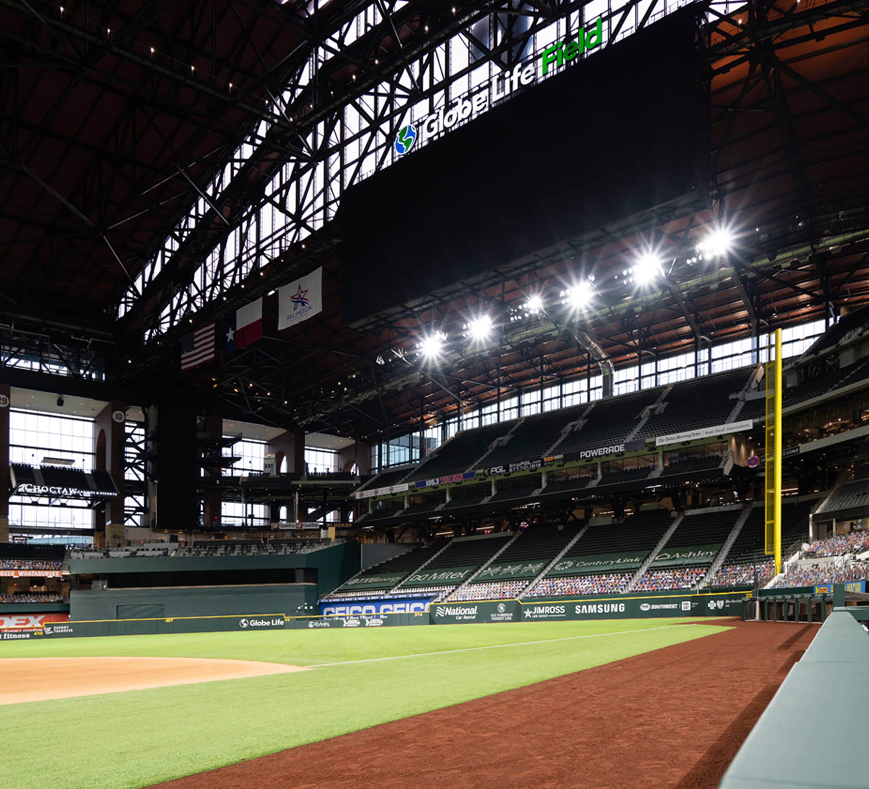 Emerging onto the field level under the glowing lights and retractable steel roof of Globe Life Field