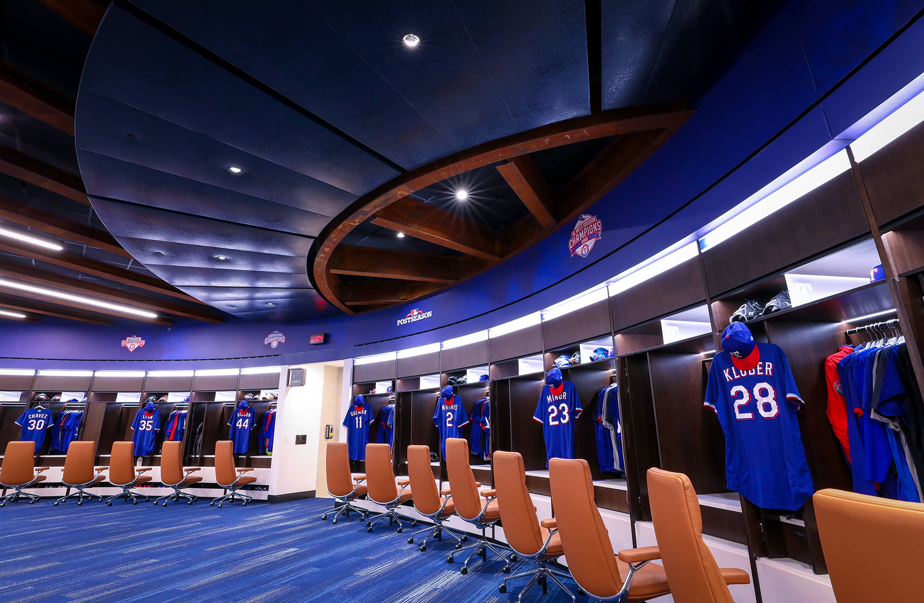 Panoramic view of the circular player locker room with wood beam ceiling and uniform stalls